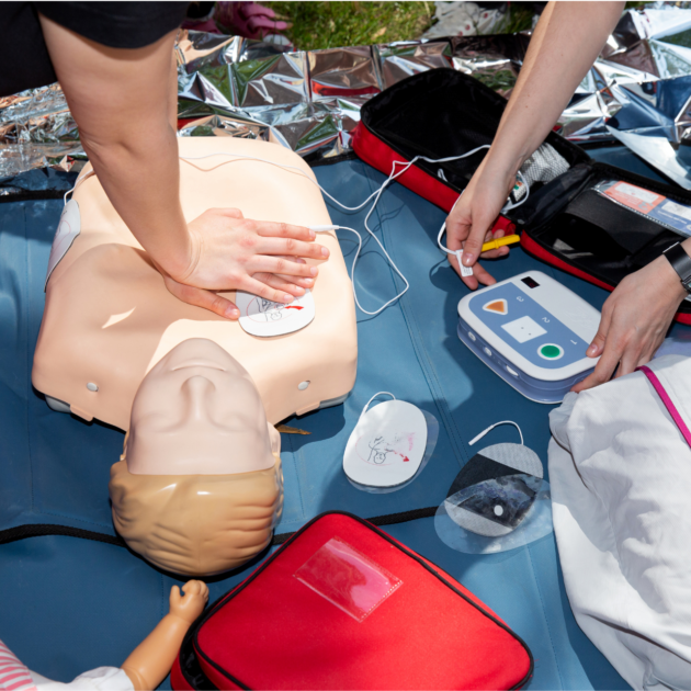 Student demonstrating skills in local NYC cpr and first aid classes with AED usage.